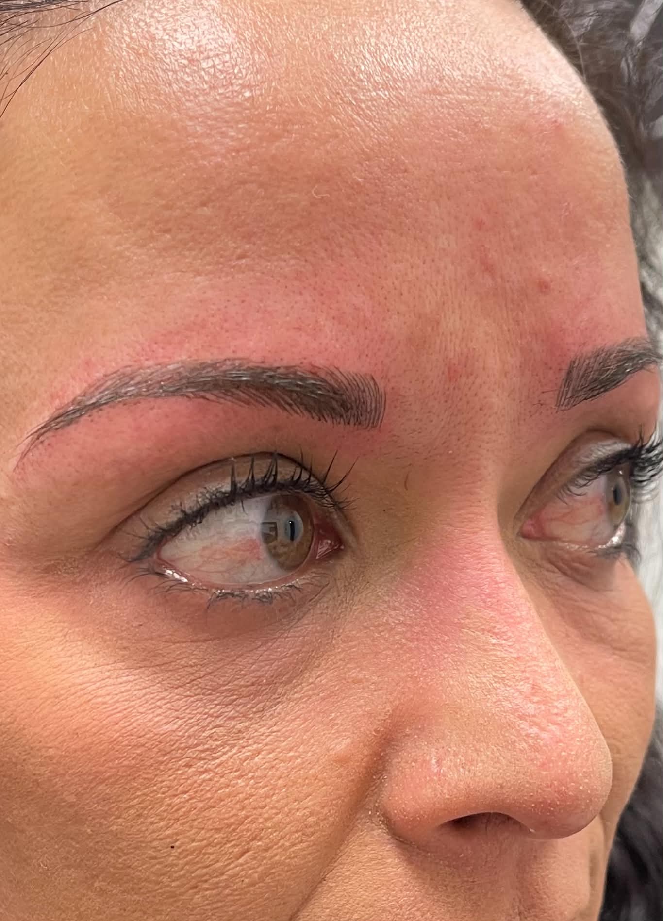 Close-up of natural microbladed brow strokes